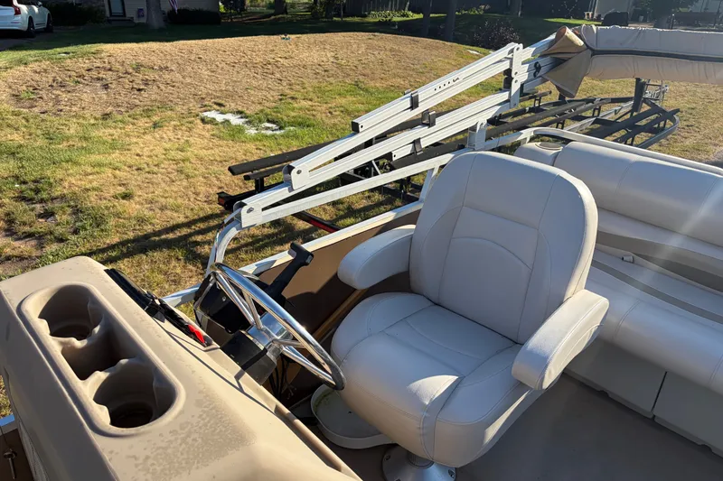Slide: The Image of 1984 Ercoa Captain 21 boat interior with steering wheel and white captain's chair. - 6