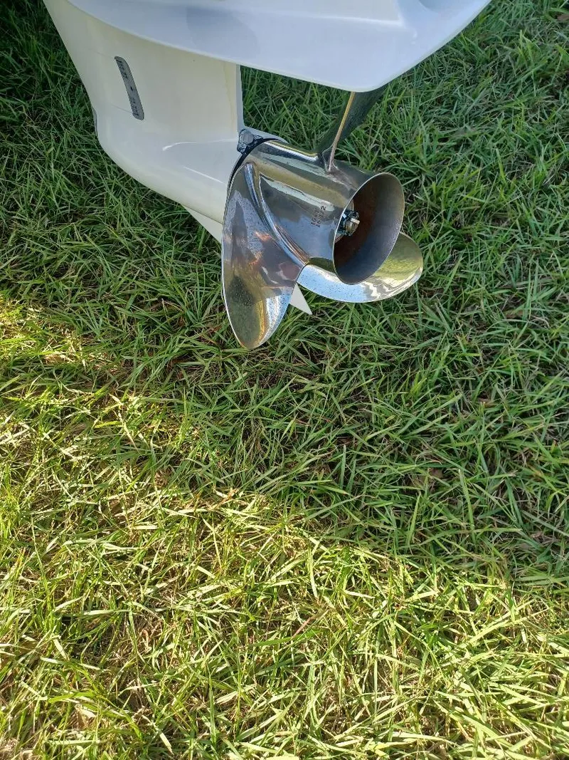 Slide: The Image of 2022 Everglades 243 Center Console boat propeller on grass. - 32
