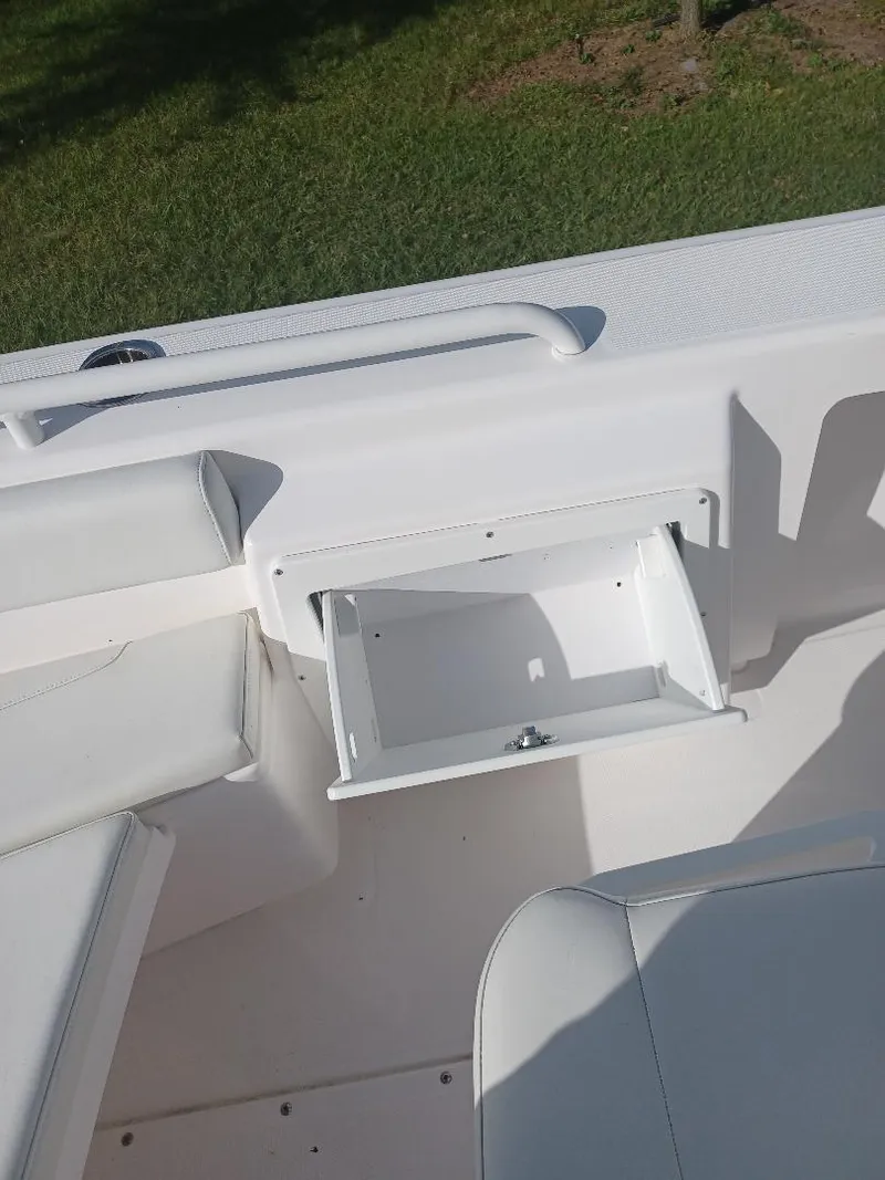 Slide: The Image of 2022 Everglades 243 Center Console boat interior with open storage compartment. - 22