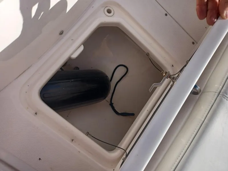Slide: The Image of Storage compartment on 2022 Everglades 243 Center Console boat with fender inside. - 28