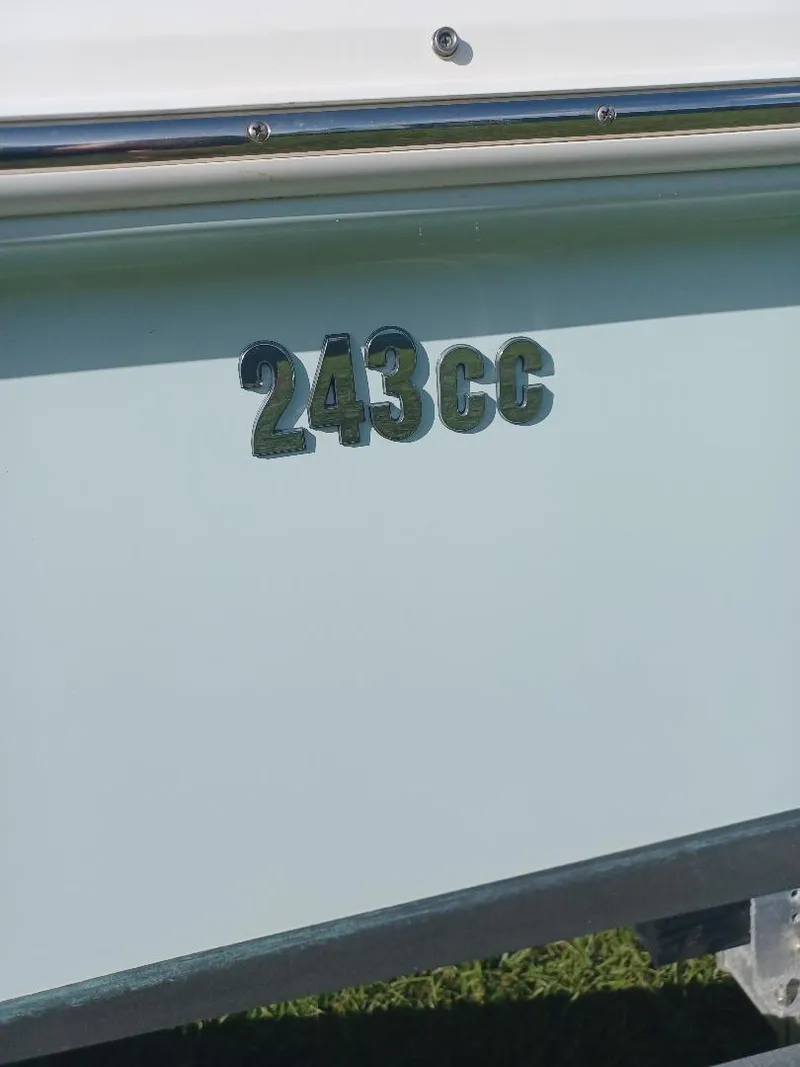 Slide: The Image of 2022 Everglades 243 Center Console boat, side view with "243CC" emblem. - 33