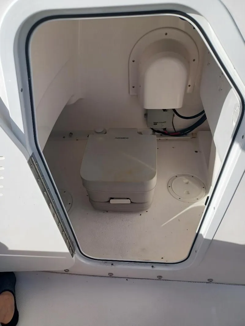 Slide: The Image of 2022 Everglades 243 Center Console boat interior with compact marine toilet. - 17