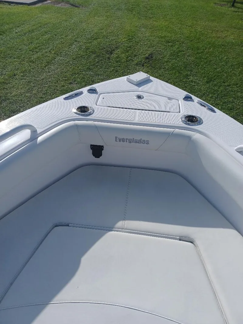 Slide: The Image of 2022 Everglades 243 Center Console boat interior with cushioned seating and cup holders. - 24