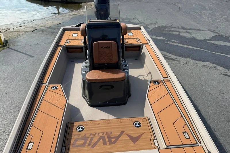 Slide: The Image of 2027 Avid 207 Recon boat with sleek deck design and modern seating. - 19