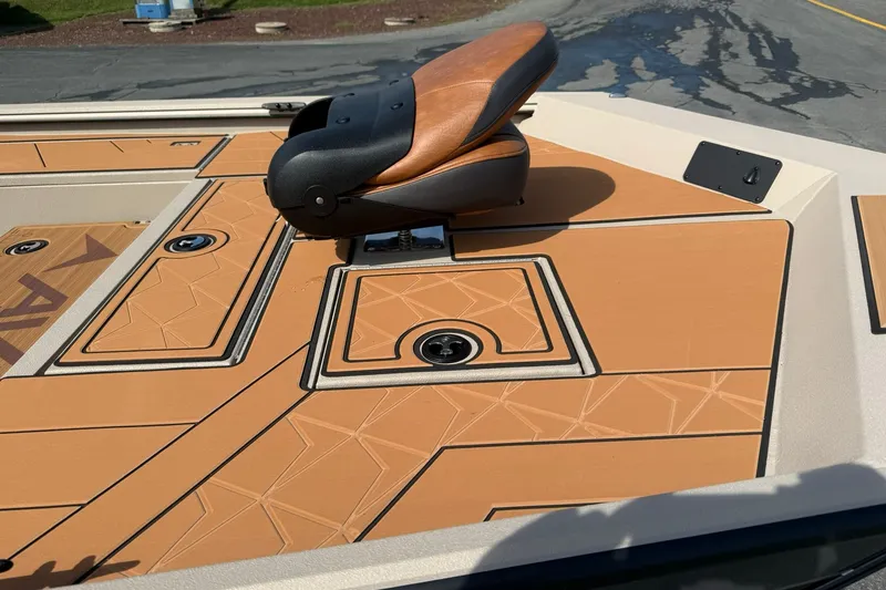 Slide: The Image of Avid 207 Recon 2027 boat deck with tan geometric design and cushioned seat. - 9