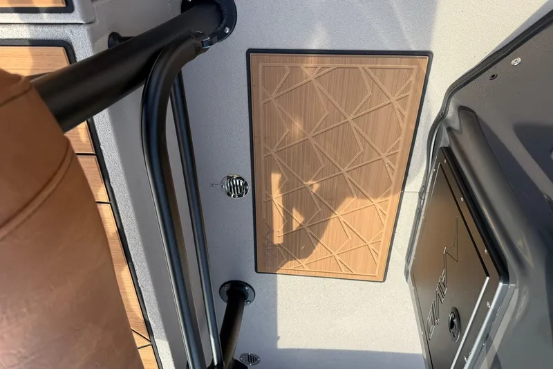 Slide: The Image of Interior of 2027 Avid 207 Recon boat with wood paneling and metal fixtures. - 16