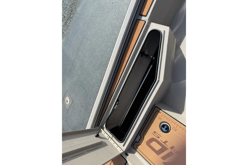 Slide: The Image of Open storage compartment on 2027 Avid 207 Recon boat deck. - 20