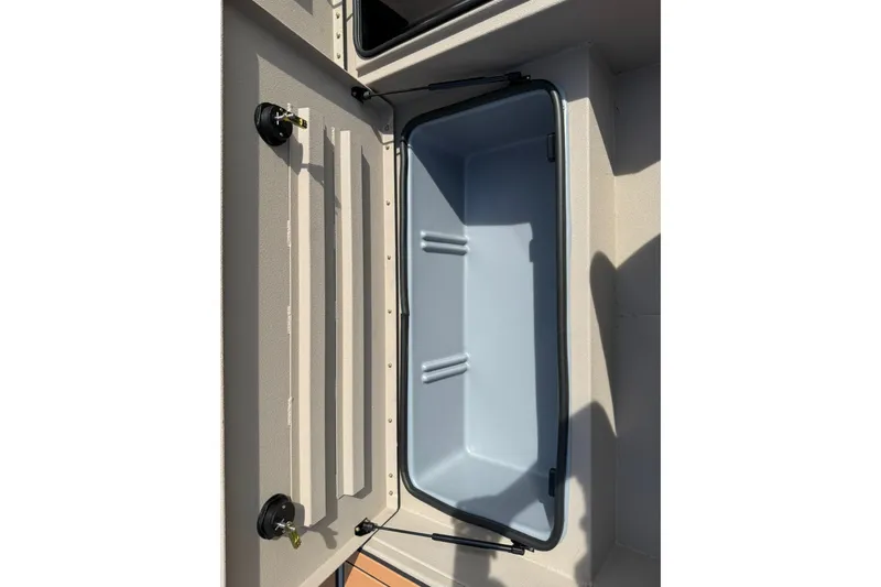 Slide: The Image of Open storage compartment of 2027 Avid 207 Recon boat, showcasing interior design. - 21