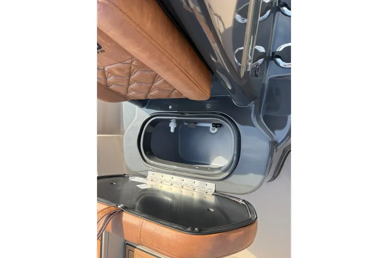 Slide: The Image of Open storage compartment in Avid 207 Recon, 2027 model, with brown leather detailing. - 17