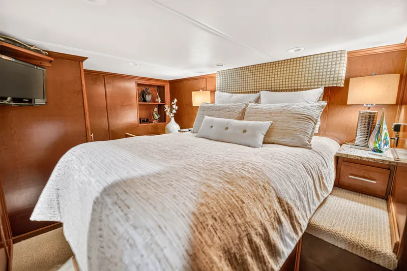Slide: The Image of Luxurious bedroom interior on 2011 STARDUST 18 x 85 houseboat, featuring elegant bedding and warm lighting. - 19