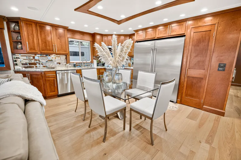 Slide: The Image of Luxurious kitchen interior on STARDUST 18 x 85 houseboat, featuring modern appliances and elegant dining area. - 13