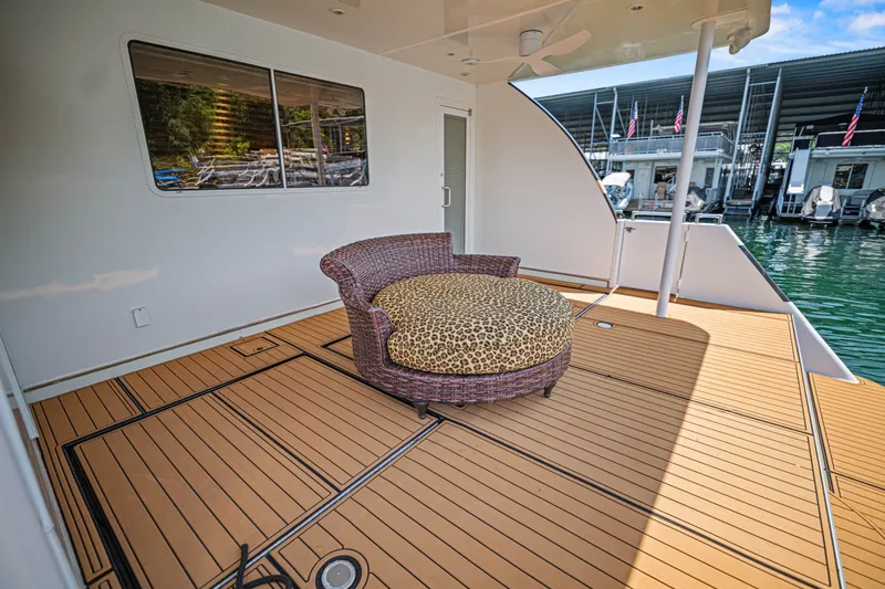 Slide: The Image of Spacious deck of 2011 STARDUST 18 x 85 houseboat with wicker seating and scenic marina view. - 23