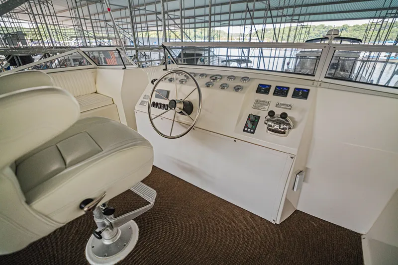 Slide: The Image of Captain's helm of 2011 STARDUST 18 x 85 houseboat with steering wheel and controls. - 25