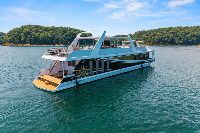 Slide: The Image of Luxurious 2011 STARDUST 18 x 85 houseboat on serene lake with lush forest backdrop. - 3