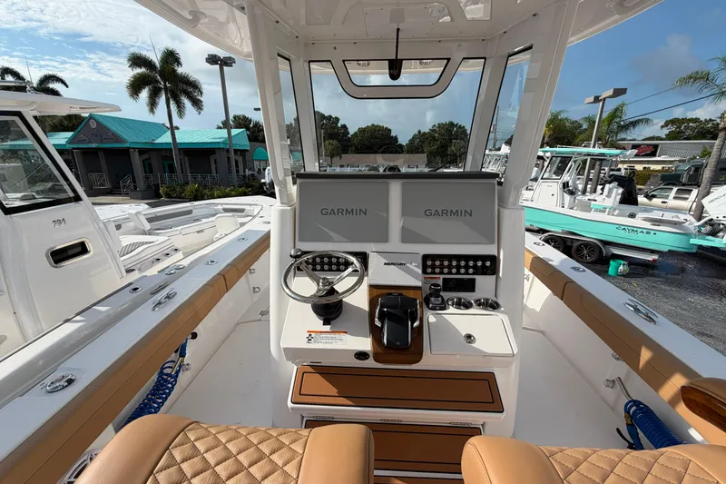 Slide: The Image of Interior view of 2027 Caymas 29 CT boat with Garmin navigation system and luxurious seating. - 9