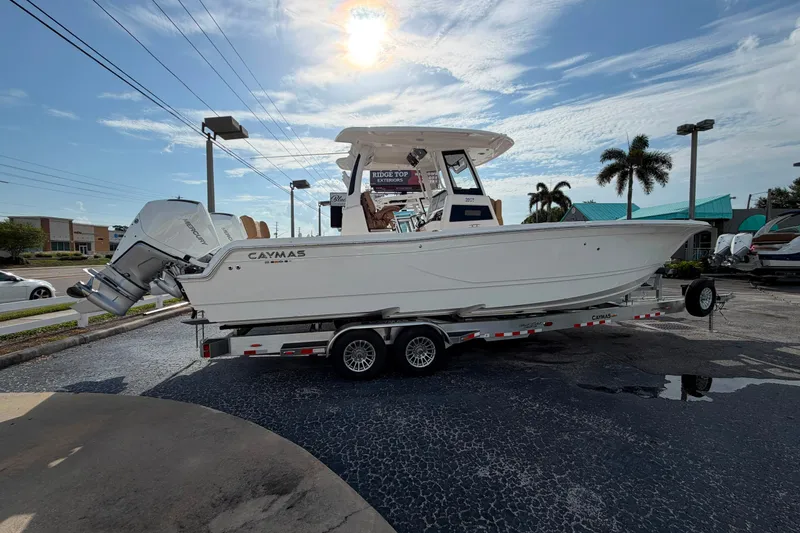 The Image of 2027 Caymas 29 CT boat on trailer under a sunny sky, parked outdoors. - 1