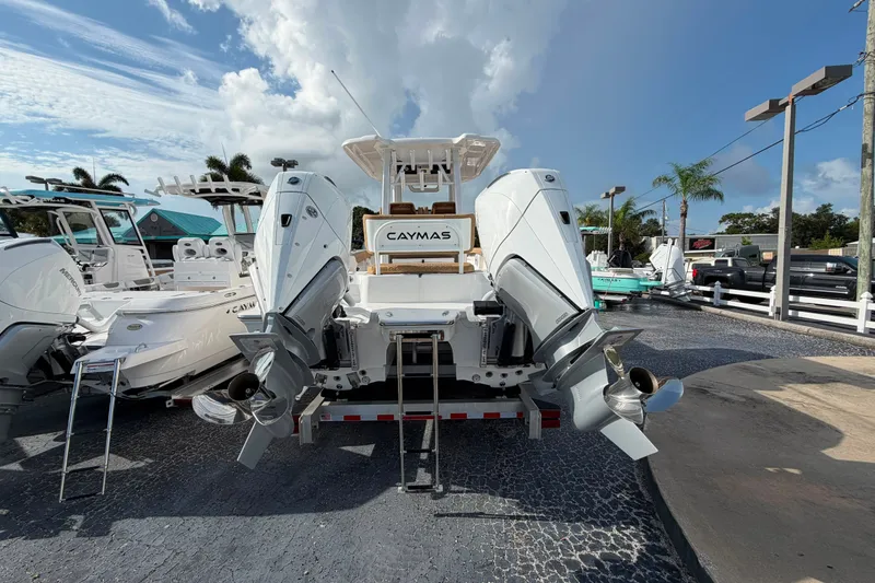 Slide: The Image of 2027 Caymas 29 CT boat with dual outboard motors in a dealership lot. - 4