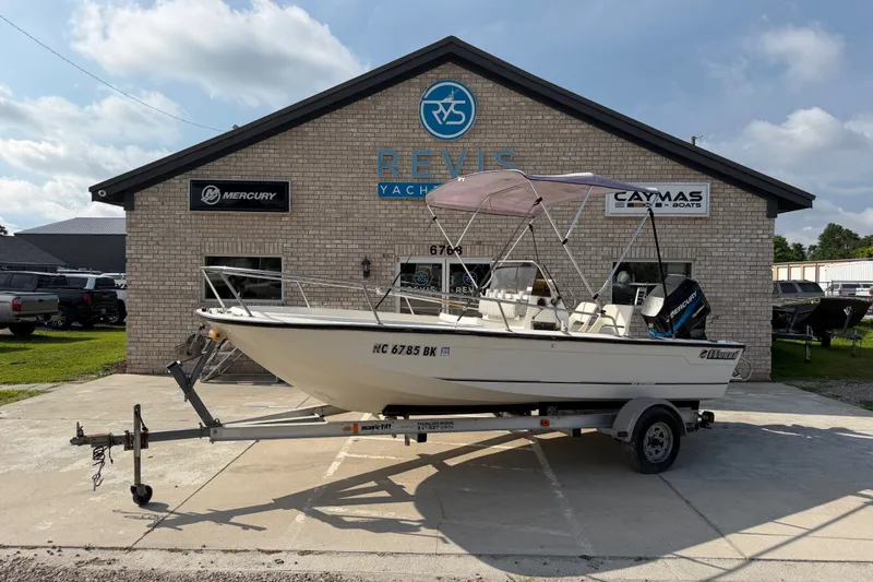 The Image of 1988 Wahoo 1850 boat on trailer outside Revis Yachts building. - 0