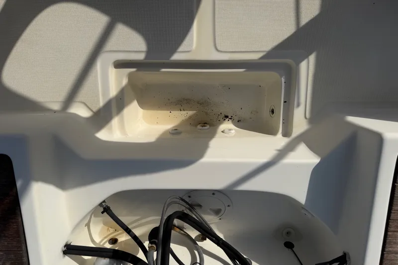 Slide: The Image of Interior view of a 1988 Wahoo 1850 boat showing storage compartment and wiring. - 21