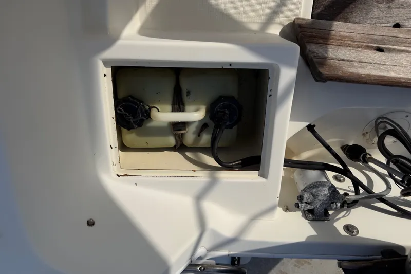 Slide: The Image of 1988 Wahoo 1850 boat fuel compartment with visible wiring and components. - 23