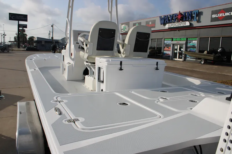 Slide: The Image of 2025 Mamba 24 Cat Elite boat at dealership, showcasing spacious deck and seating. - 19