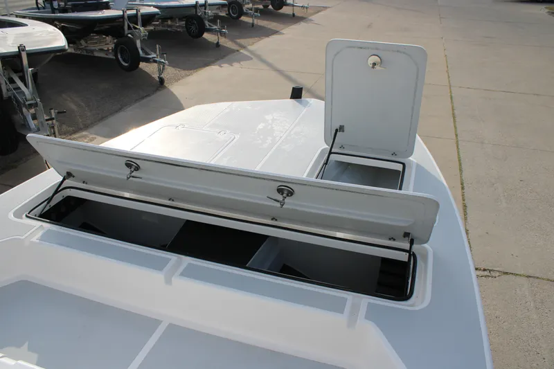 Slide: The Image of 2025 Mamba 24 Cat Elite boat with open storage compartments on a trailer. - 13
