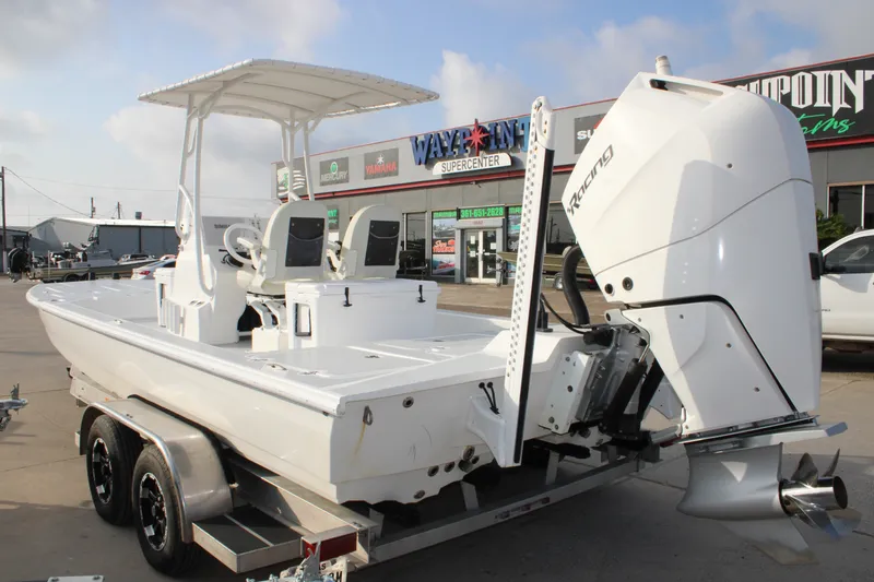 Slide: The Image of 2025 Mamba 24 Cat Elite boat with powerful outboard motor, parked at dealership. - 18