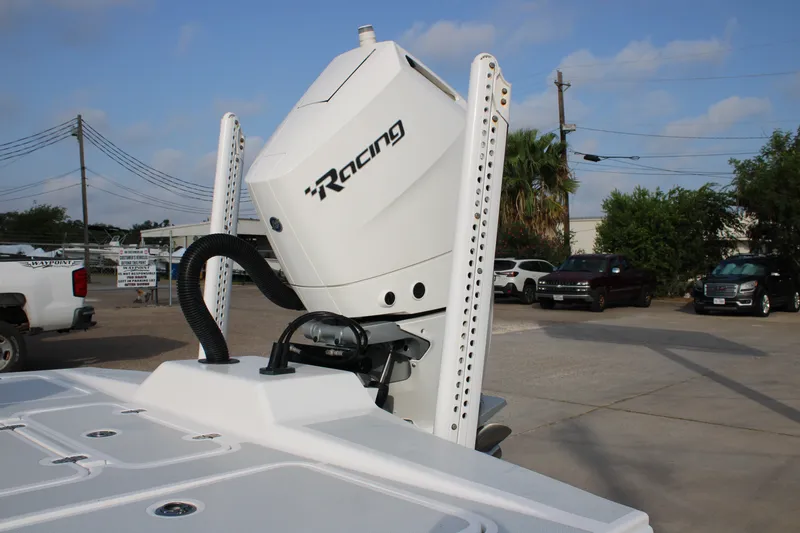 Slide: The Image of 2025 Mamba 24 Cat Elite boat with powerful racing engine in a parking lot. - 21