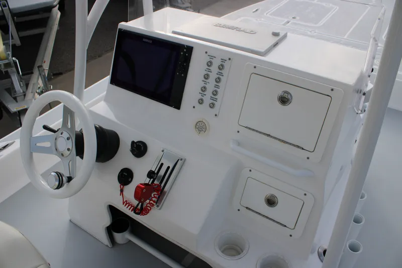 Slide: The Image of 2025 Mamba 24 Cat Elite boat console with steering wheel, controls, and storage compartments. - 15