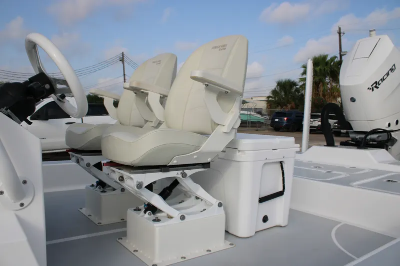 Slide: The Image of 2025 Mamba 24 Cat Elite boat interior with dual seats and steering wheel. - 22