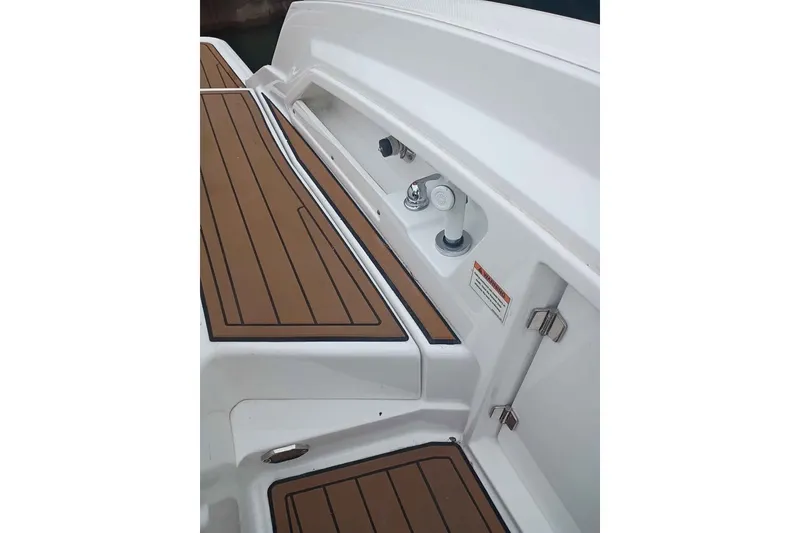 Slide: The Image of 2021 Monterey 328SS Super Sport boat deck with wood finish and utility fixtures. - 15