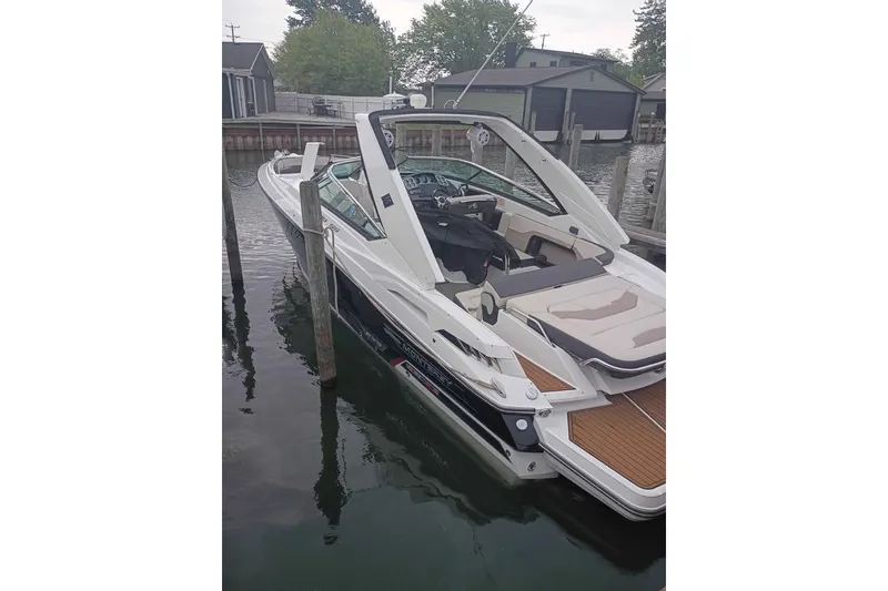 Slide: The Image of 2021 Monterey 328SS Super Sport boat docked in a marina, featuring sleek design and spacious seating. - 23