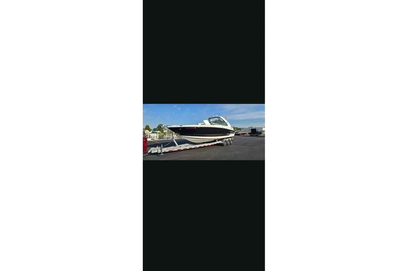 Slide: The Image of 2021 Monterey 328SS Super Sport boat on trailer under clear sky. - 18