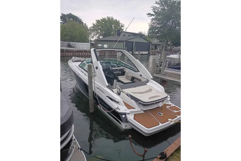 Slide: The Image of 2021 Monterey 328SS Super Sport boat docked in a serene marina setting. - 22