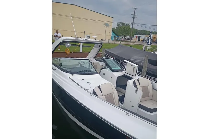 Slide: The Image of 2021 Monterey 328SS Super Sport boat docked, featuring sleek design and comfortable seating. - 24