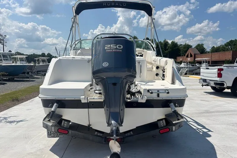 Slide: The Image of 2009 Robalo R227 Dual Console boat with 250 horsepower engine, docked outdoors. - 5