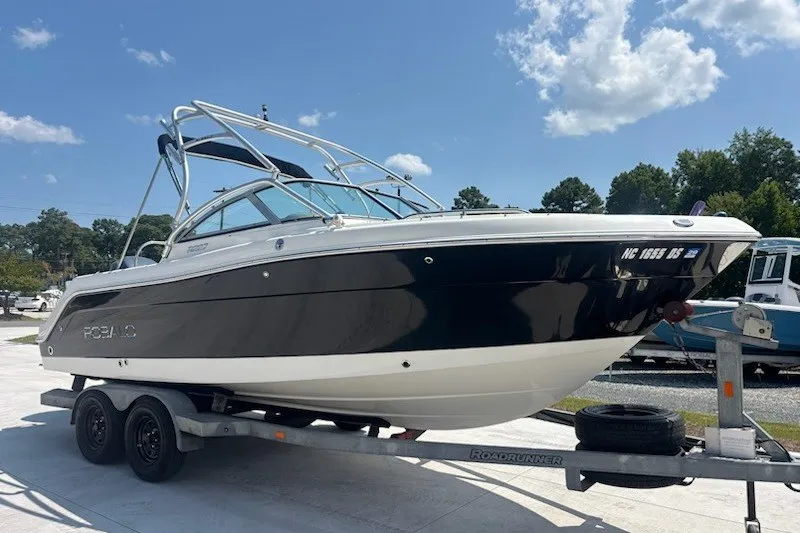 Slide: The Image of 2009 Robalo R227 Dual Console boat on trailer under clear sky. - 4