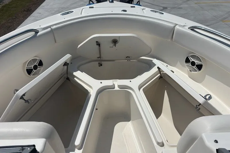 Slide: The Image of 2009 Robalo R227 Dual Console boat interior with open storage compartments and speakers. - 11