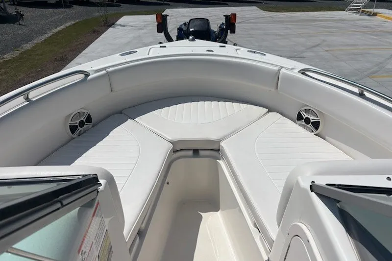 Slide: The Image of 2009 Robalo R227 Dual Console boat interior with white seating and speakers. - 12