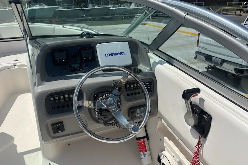 Slide: The Image of 2009 Robalo R227 Dual Console boat dashboard with steering wheel and Lowrance navigation system. - 10