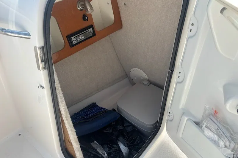 Slide: The Image of Interior cabin of 2009 Robalo R227 Dual Console boat with storage and amenities. - 13