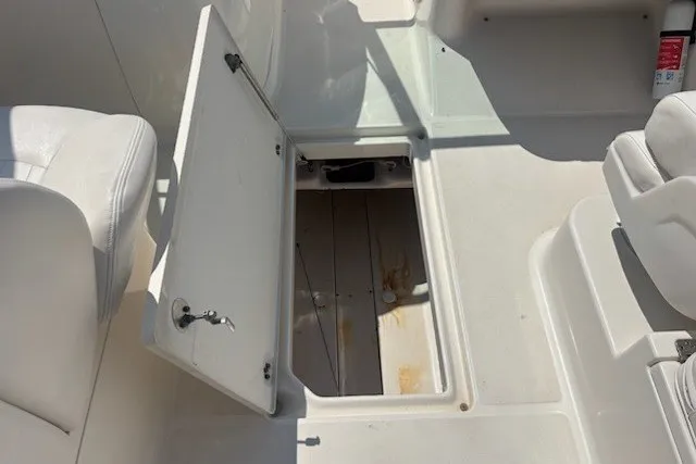 Slide: The Image of 2009 Robalo R227 Dual Console boat interior with open storage compartment. - 8