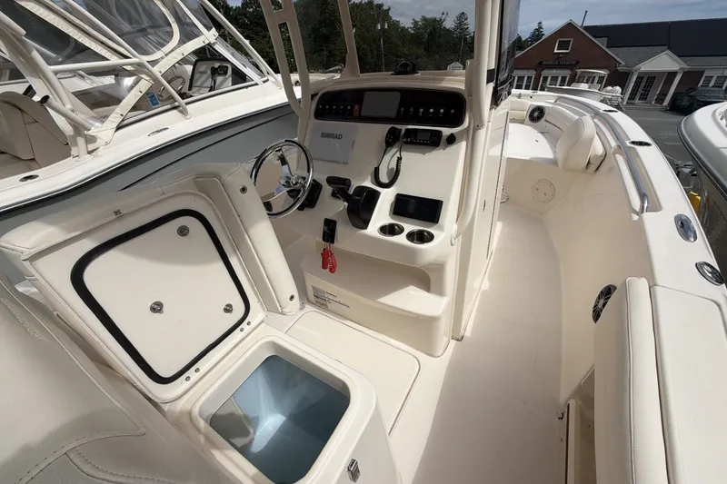 Slide: The Image of 2023 Grady-White Fisherman 216 boat interior with helm, storage, and seating. - 8
