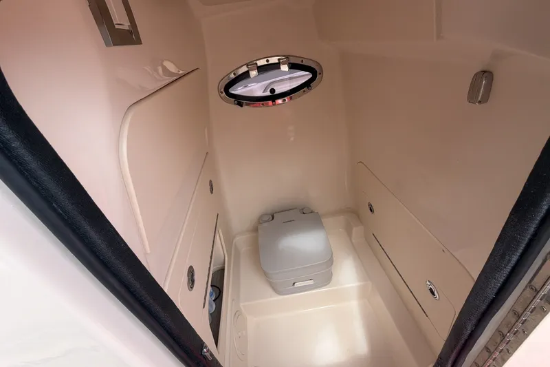 Slide: The Image of 2023 Grady-White Fisherman 216 boat interior with compact marine toilet. - 11