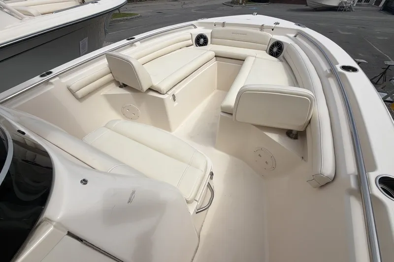 Slide: The Image of 2023 Grady-White Fisherman 216 boat interior with white cushioned seating. - 9