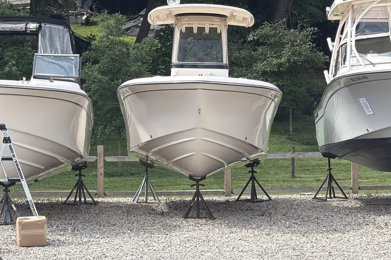 The Image of 2023 Grady-White Fisherman 216 boat on stands, surrounded by greenery. - 1
