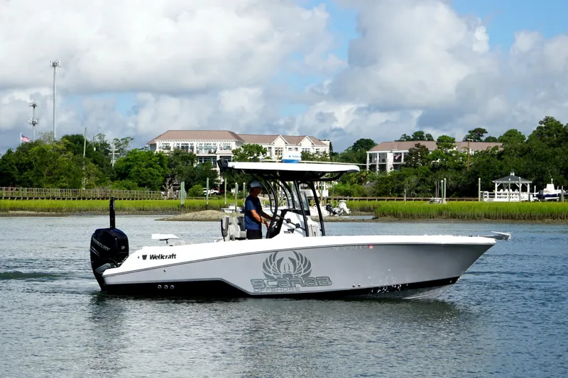 Slide: The Image of 2022 Wellcraft 242 Scarab Offshore boat cruising on a scenic waterway. - 4