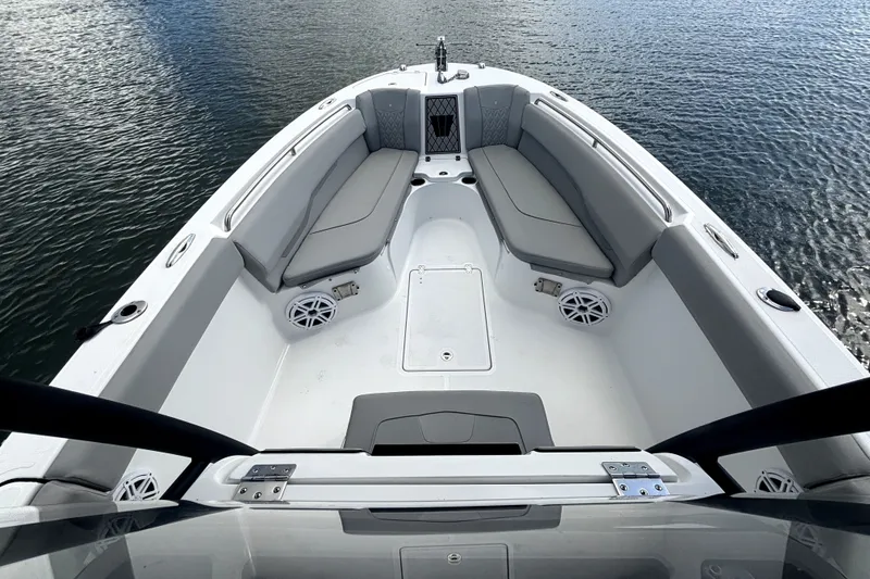 Slide: The Image of 2022 Wellcraft 242 Scarab Offshore boat interior with gray seating on calm water. - 7