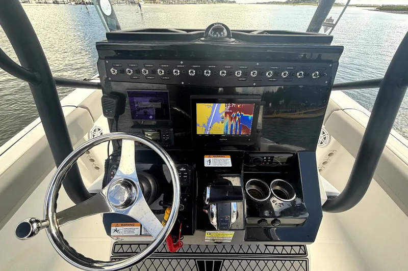 Slide: The Image of 2022 Wellcraft 242 Scarab Offshore helm with advanced navigation and control systems. - 8