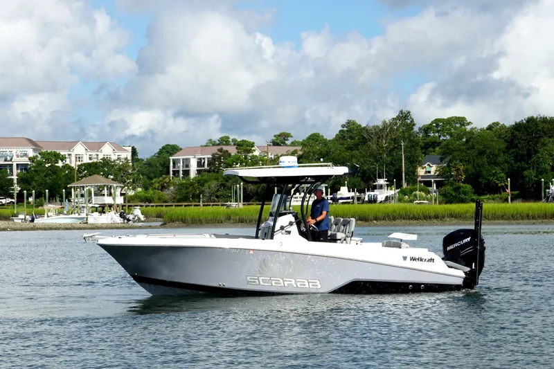 The Image of 2022 Wellcraft 242 Scarab Offshore boat cruising on a scenic waterway. - 0